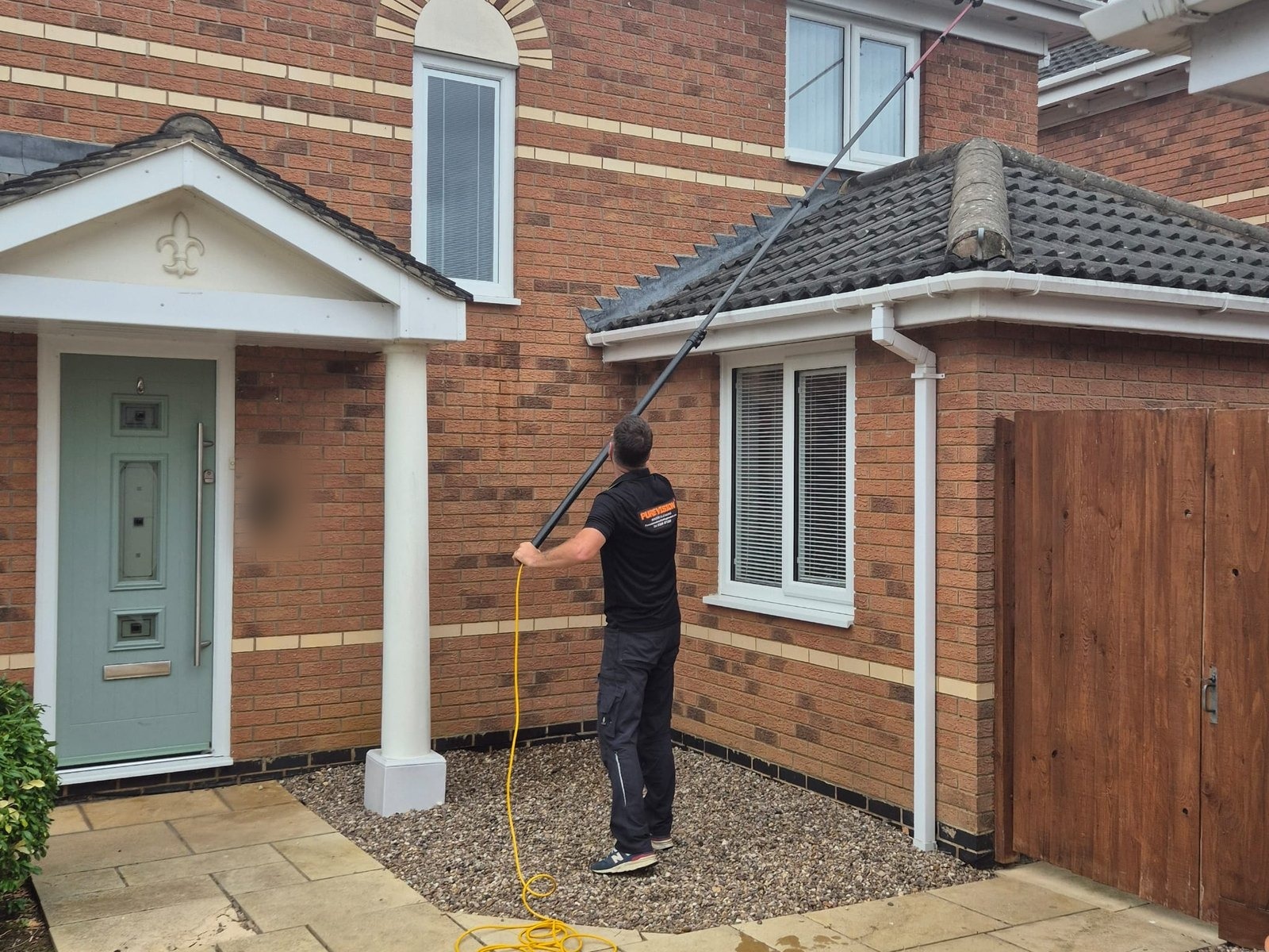 Cleaning upstairs windows from the ground with a reach pole in Northampton